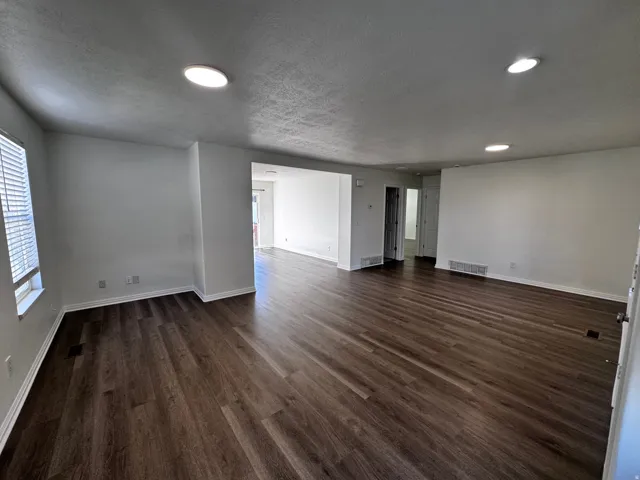 Wood-finish flooring throughout, recessed ceiling lighting, and neutral wall tones
