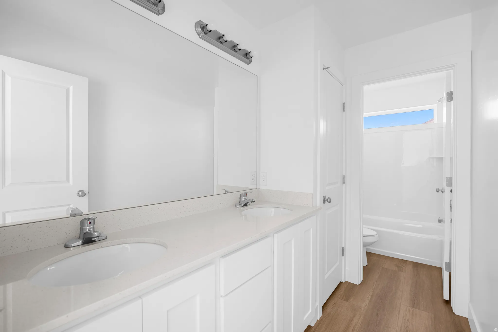 Dual vanity with a light-toned countertop and integrated sinks