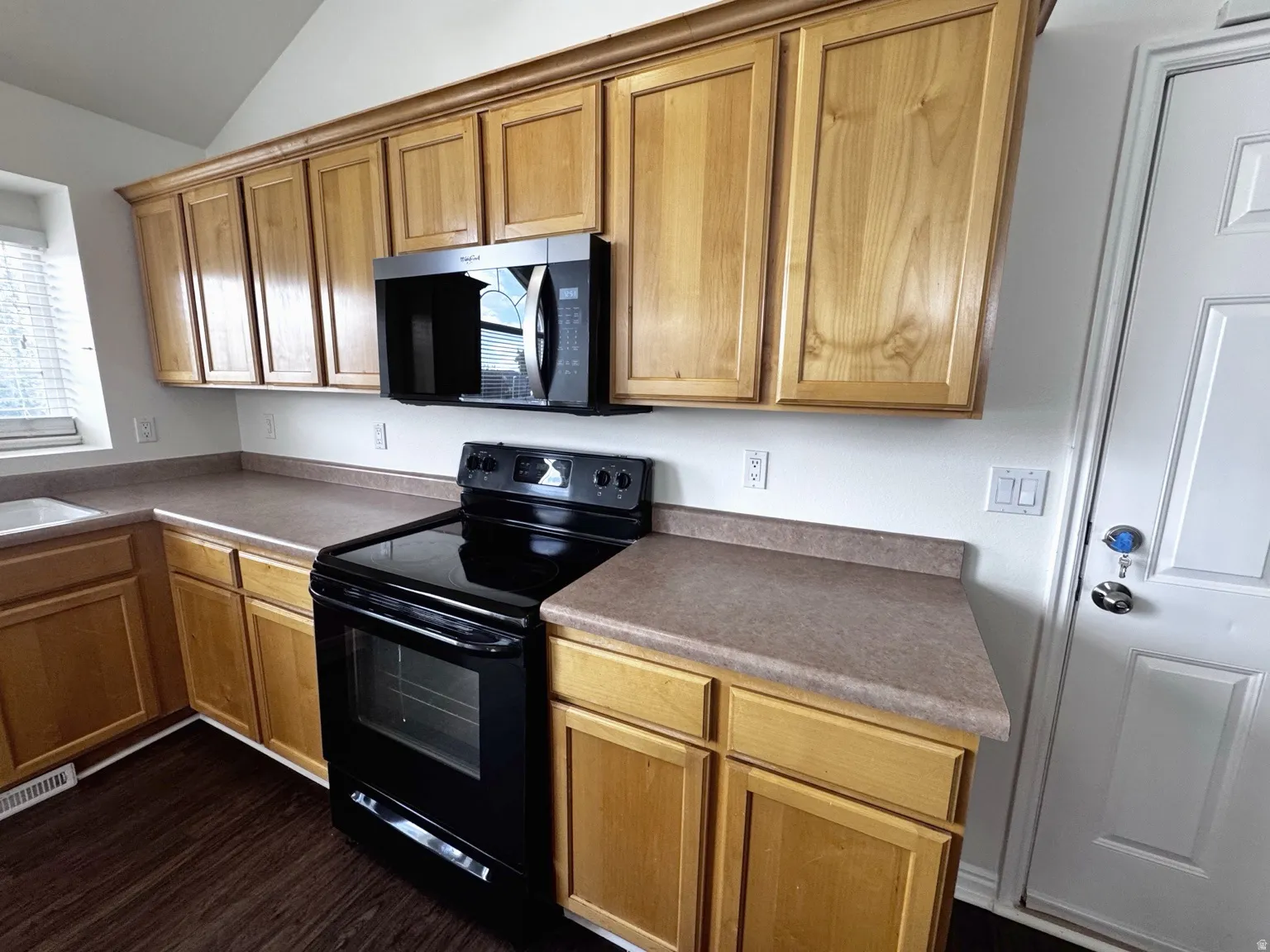 Wood-finish cabinetry paired with complementary countertops