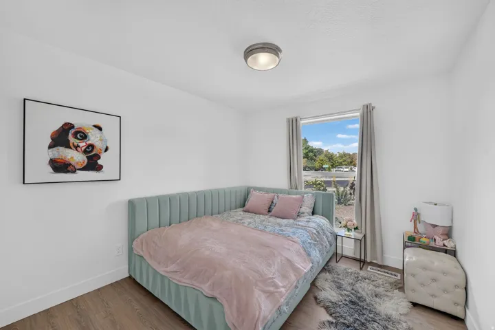 Wood-finish flooring, white walls, and a contemporary ceiling light fixture