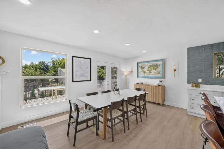 Recessed lighting illuminates wood-finish flooring