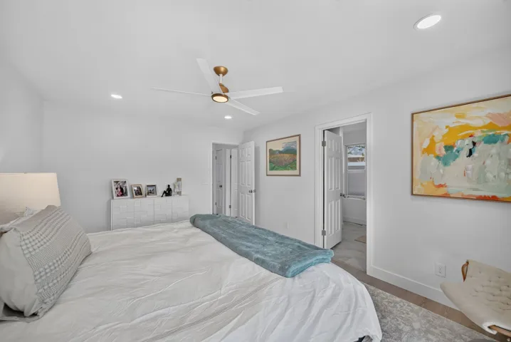 Recessed lighting, ceiling fan with integrated light, white interior doors, and wood-finish flooring