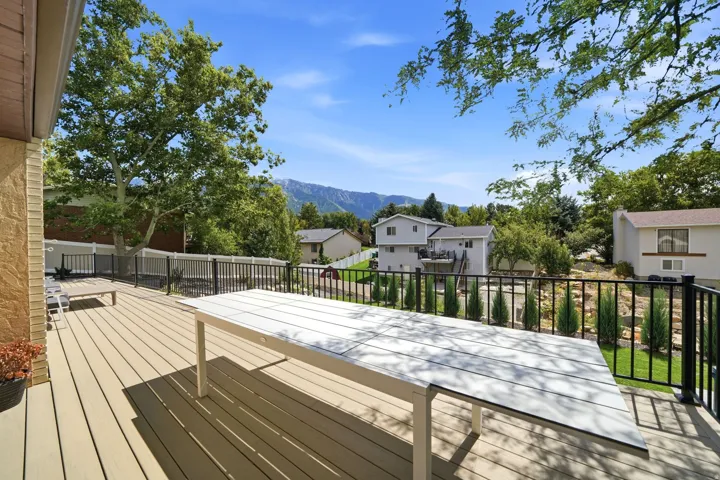 Expansive outdoor deck with composite decking and black metal railings
