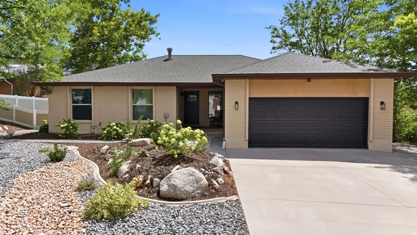 Neutral-toned exterior with a dark garage door
