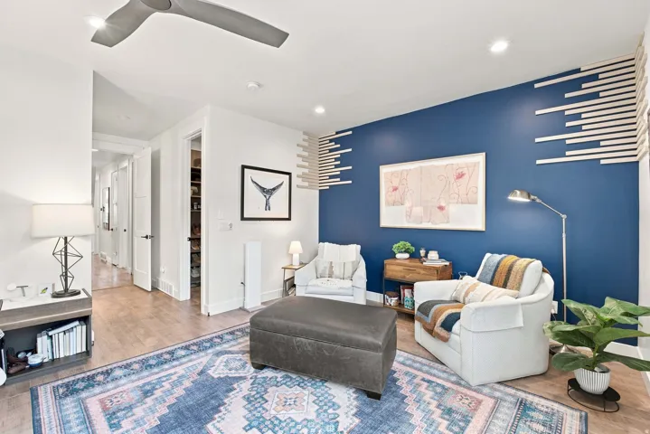 Recessed lighting, wood-finish flooring, and a contemporary ceiling fan