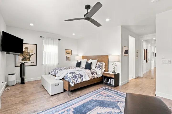 Wood-finish flooring, recessed lighting, and a contemporary ceiling fan