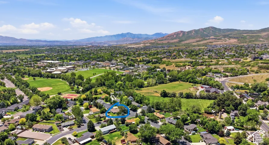 Aerial perspective featuring a residential lot with mature trees and a prominent mountain backdrop   Close to Burgess Park.