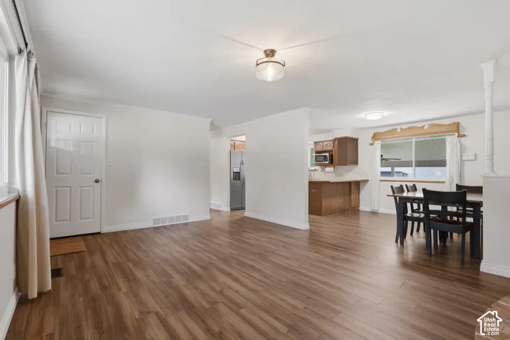 Wood-finish flooring throughout, white walls, and a recessed ceiling light fixture
