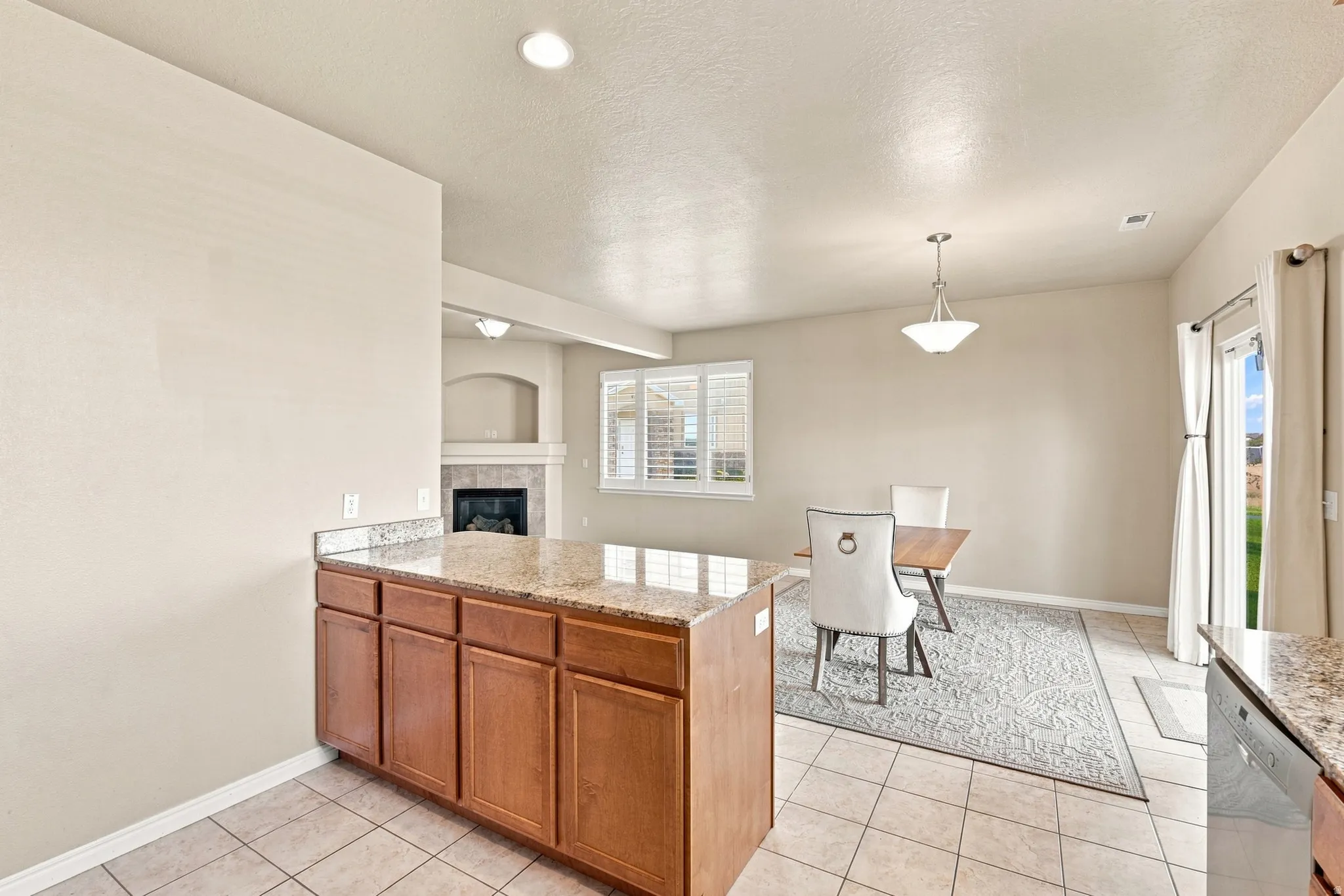 Kitchen island with granite countertop and wood-finish cabinetry