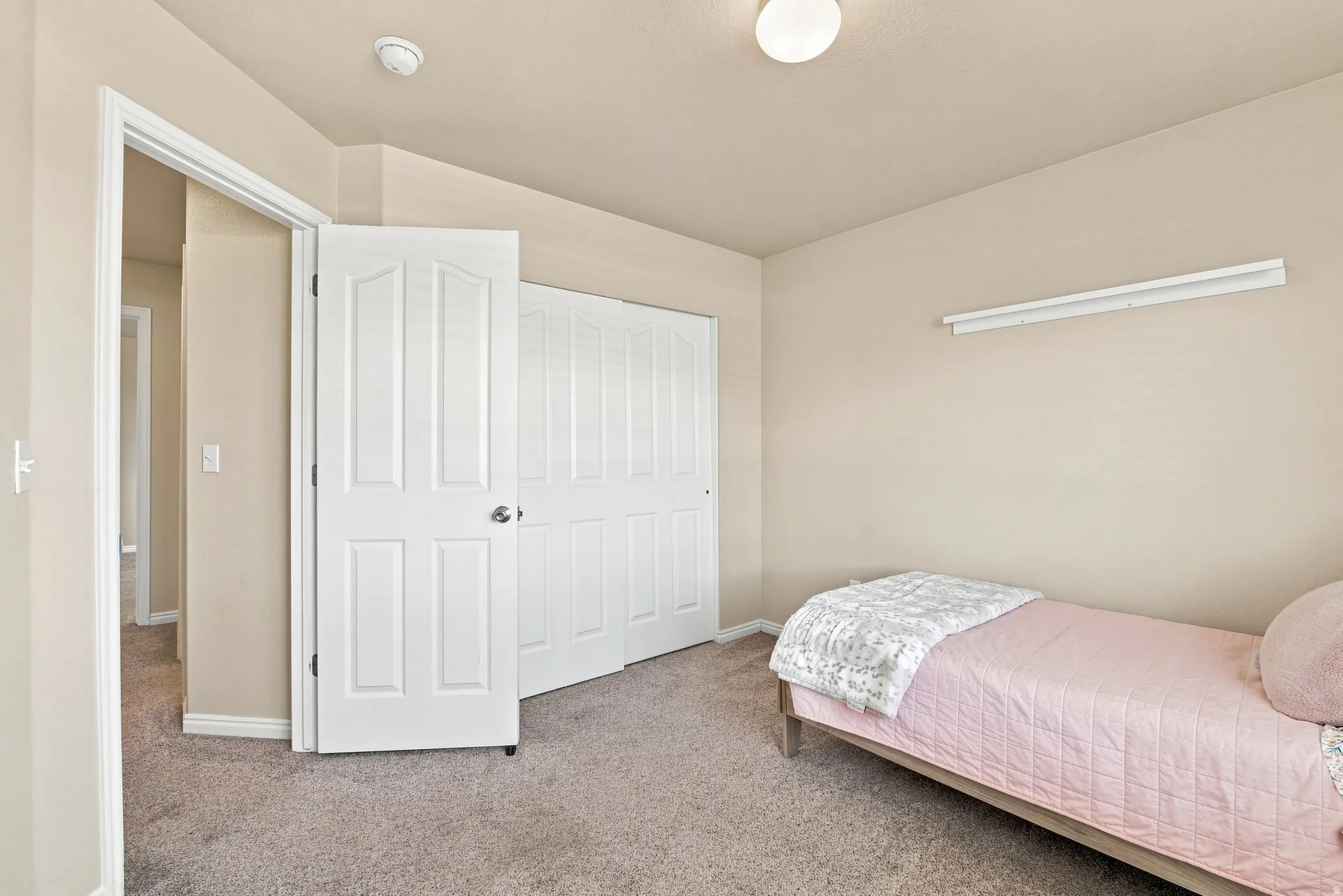 Neutral-toned walls complement plush carpeting