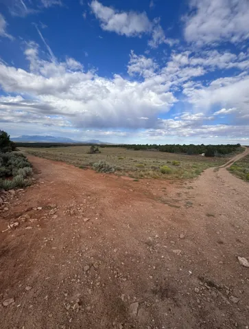 Driveway entranceExpansive undeveloped land featuring a desert landscape and distant mountains