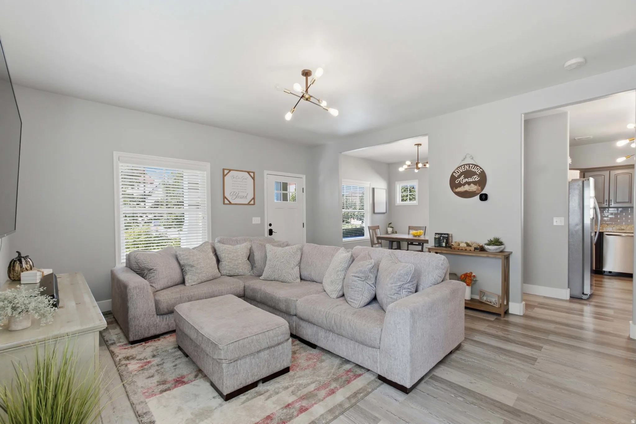 Recessed lighting throughout, wood-finish flooring, and a modern light fixture