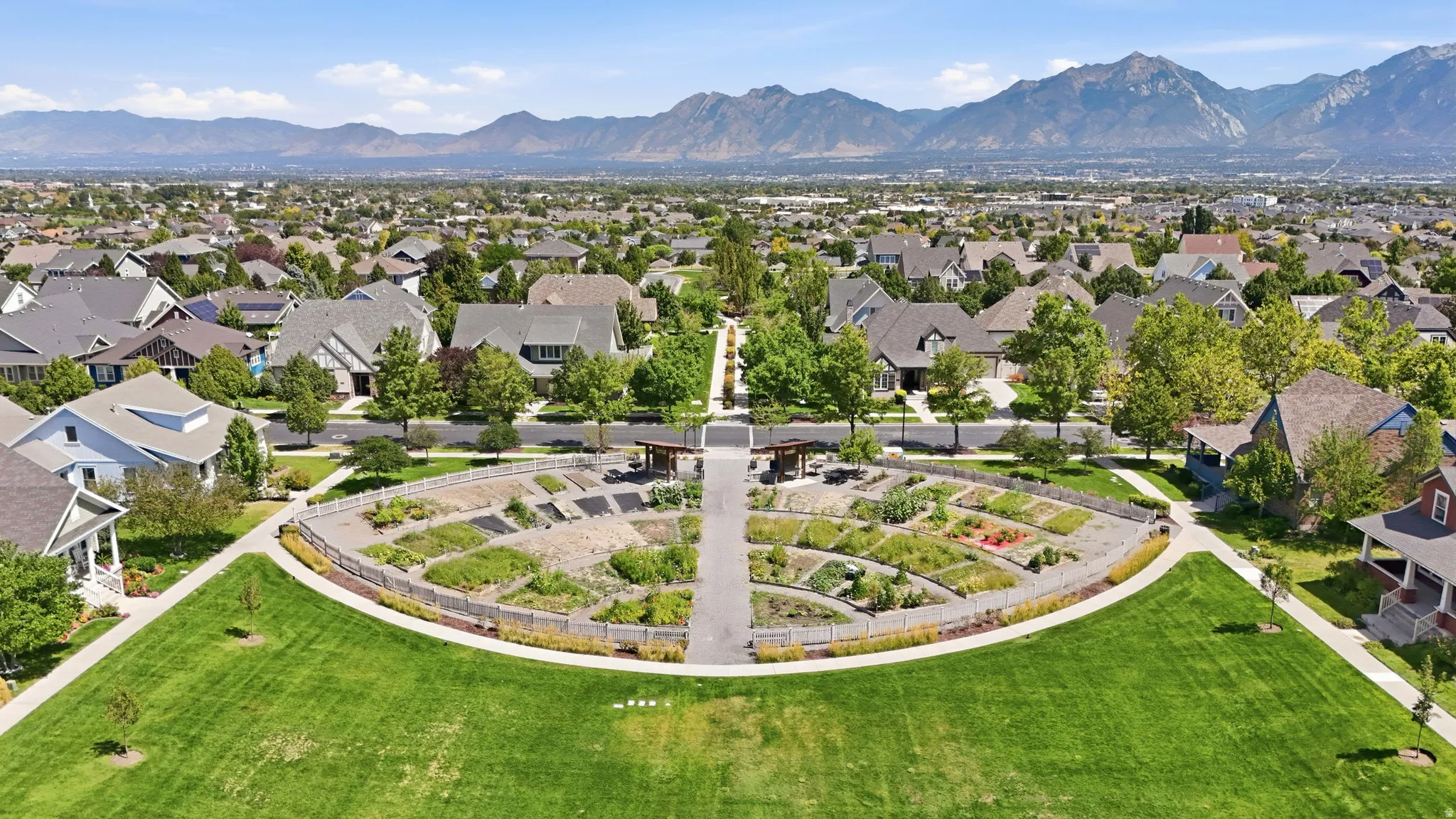 Eastlake Commons. Expansive green space featuring a curved walking path and mountain backdrop