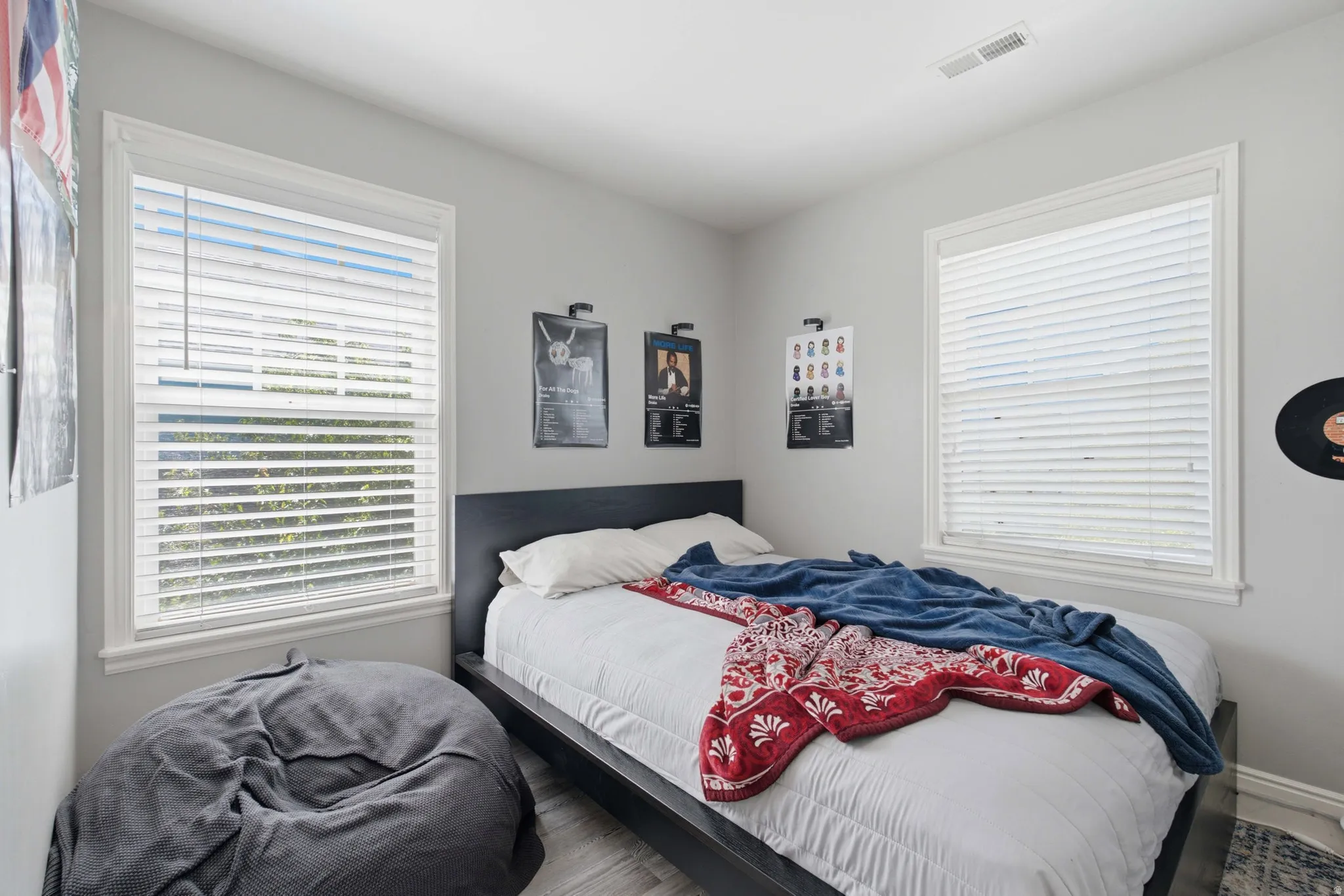 Two windows with white blinds
