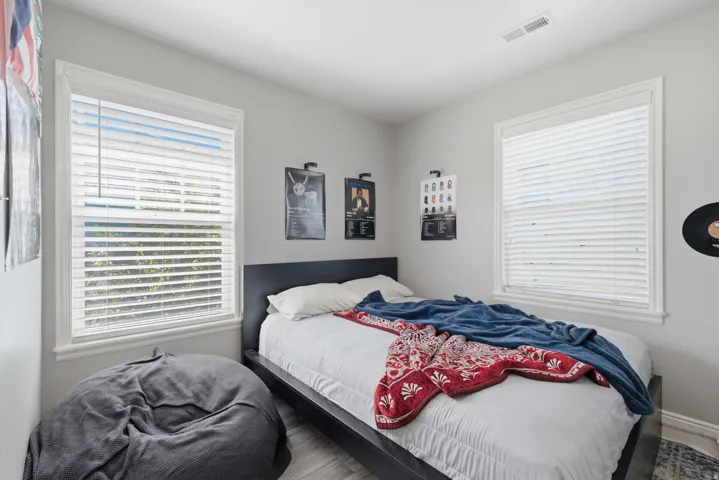 Two windows with white blinds
