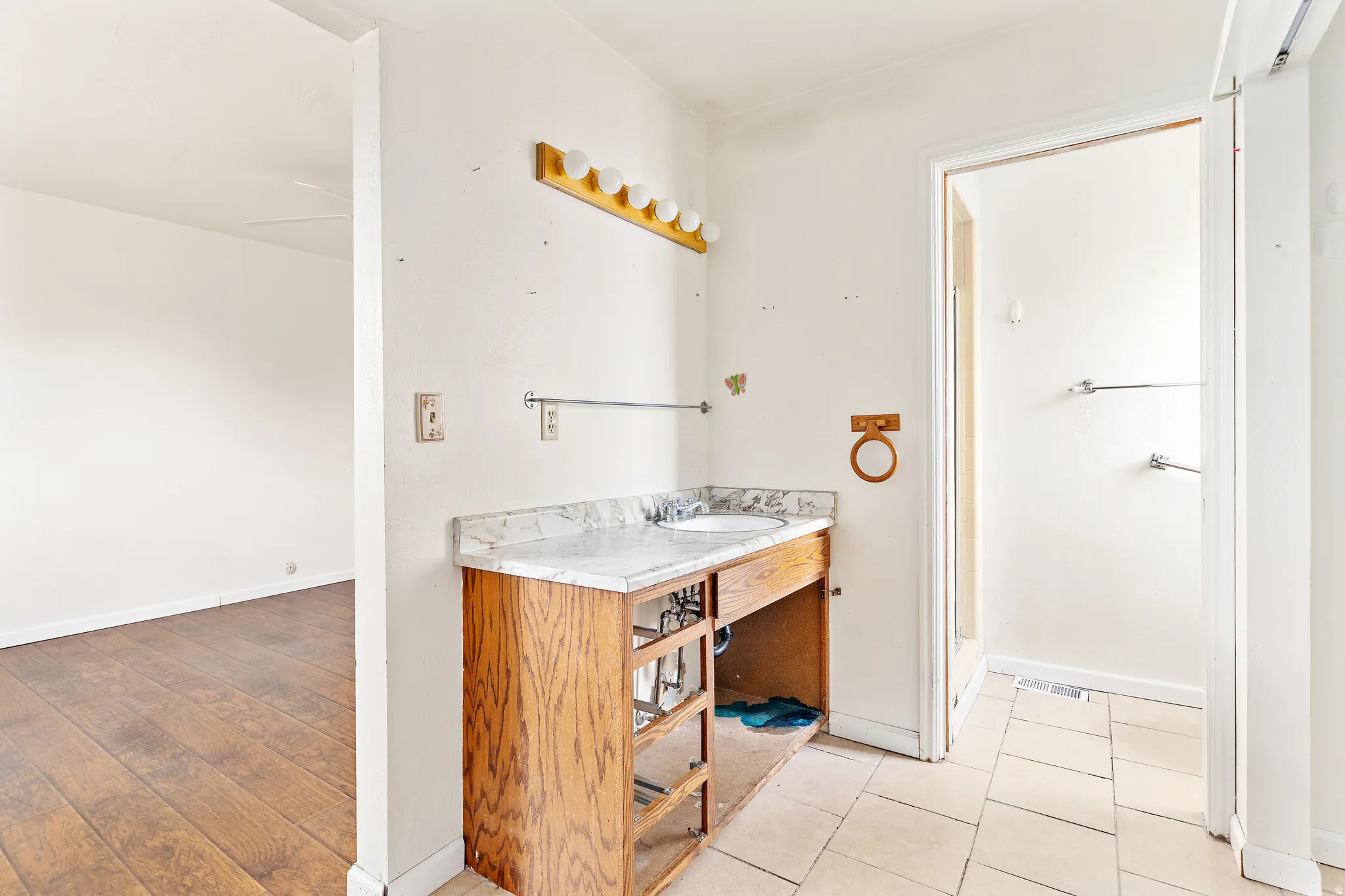 Wood-finish vanity with an integrated sink and light-colored countertop