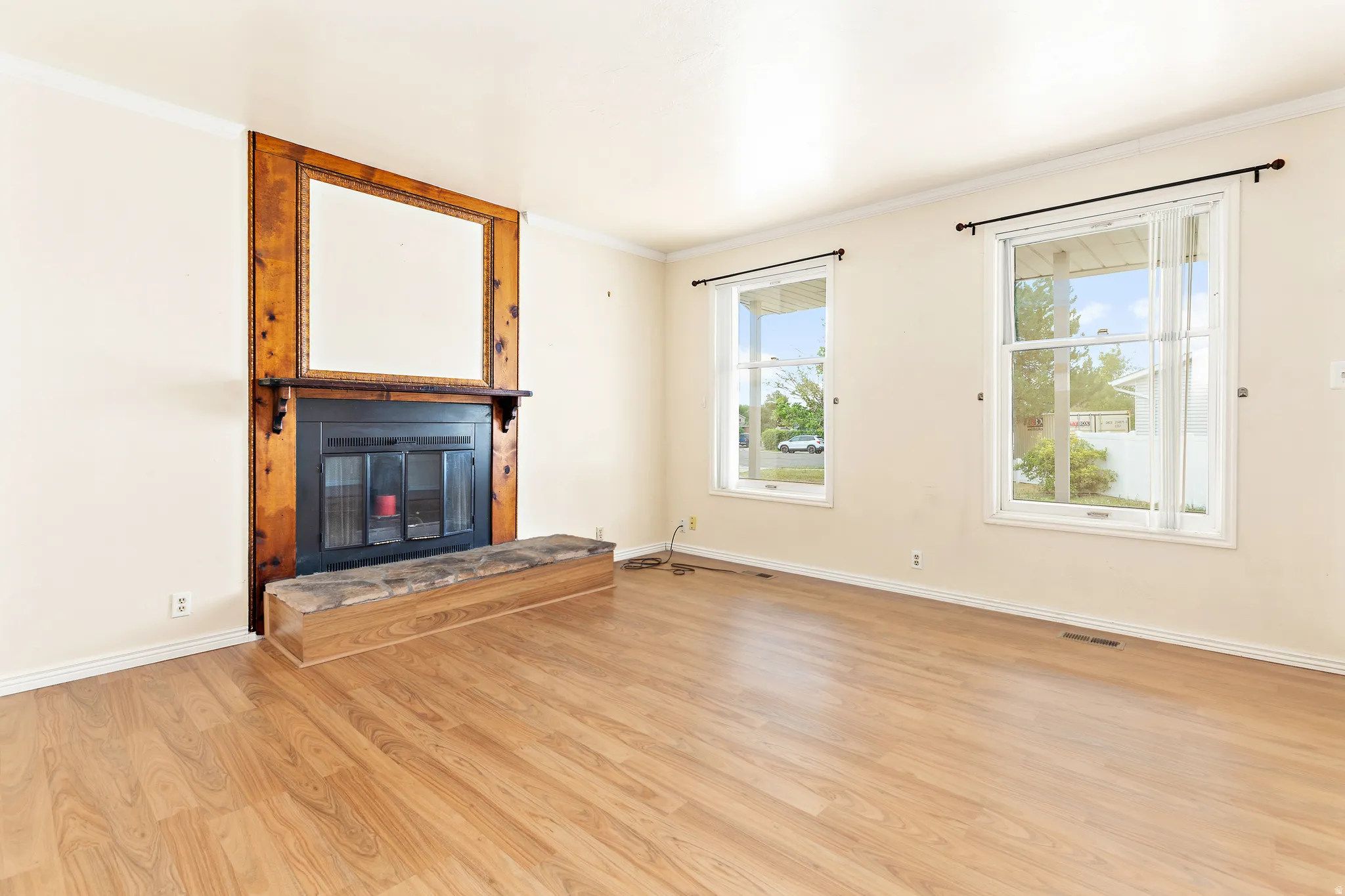 Fireplace featuring a decorative wood surround, integrated hearth, and a mantel