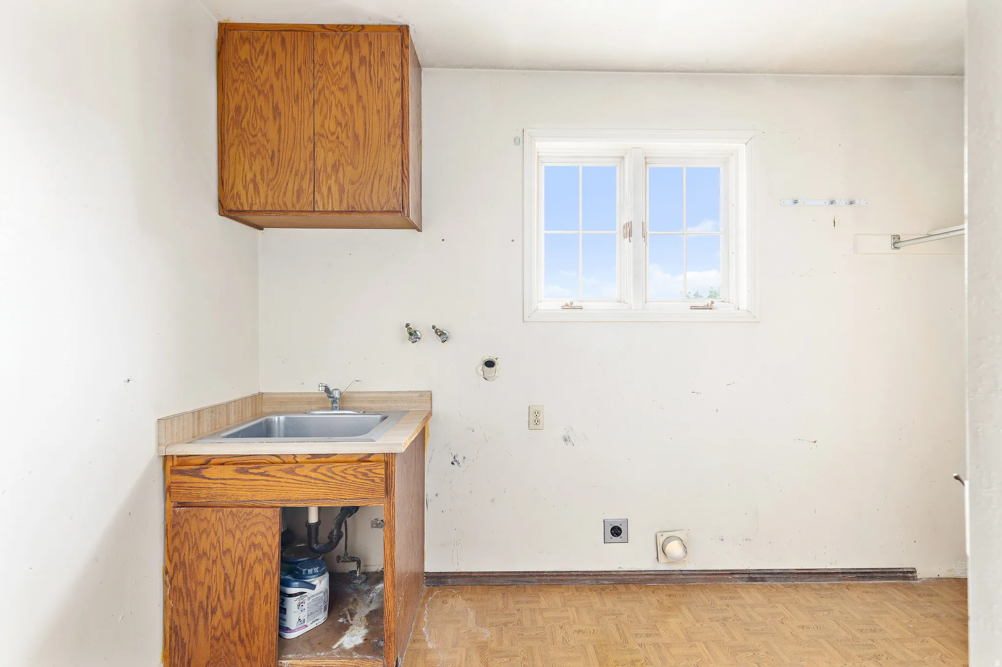 Utility sink with wood-finish cabinetry