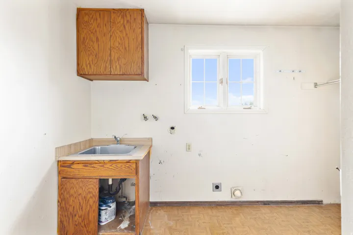 Utility sink with wood-finish cabinetry