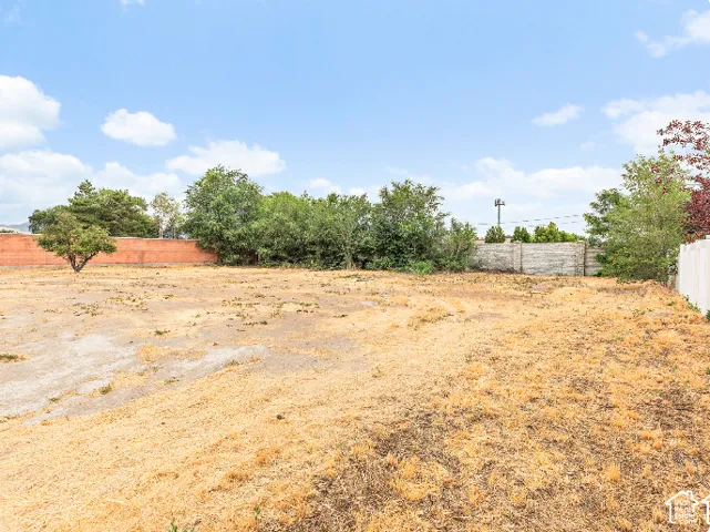 Expansive lot featuring perimeter brick and masonry wall fencing and mature trees