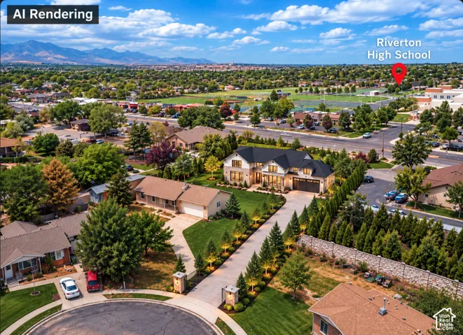 Aerial perspective featuring a multi-story residence with a high-pitched roofline, stone and siding exterior, paved circular driveway, attached multi-car garage, and mountain backdrop