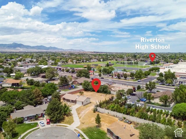 Aerial perspective showcasing a residential area with established homes and mature trees