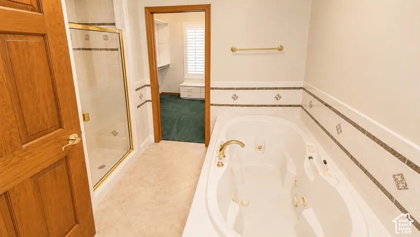 Jetted soaking tub and a separate glass-enclosed shower