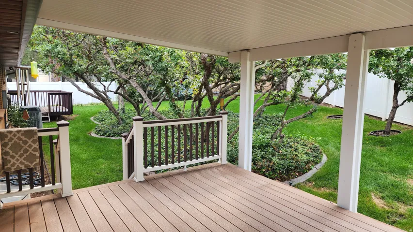Covered deck with composite decking and white railing