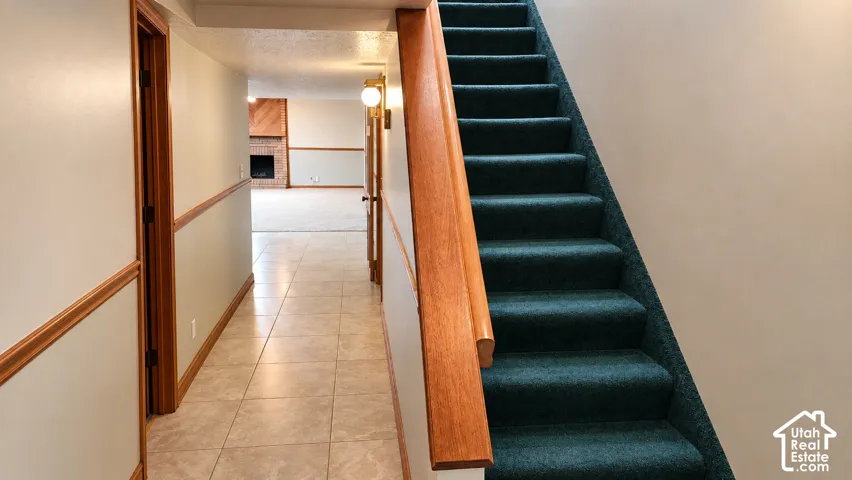 Tiled hallway flooring with wood trim and wainscoting
