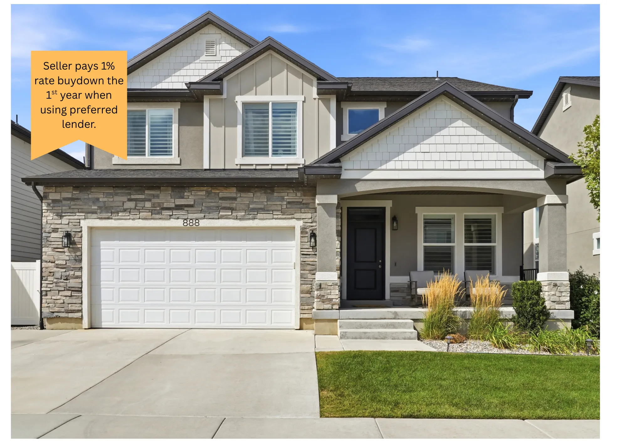 Two-story exterior with stone veneer accents, an attached two-car garage, covered porch, and well-maintained front lawn