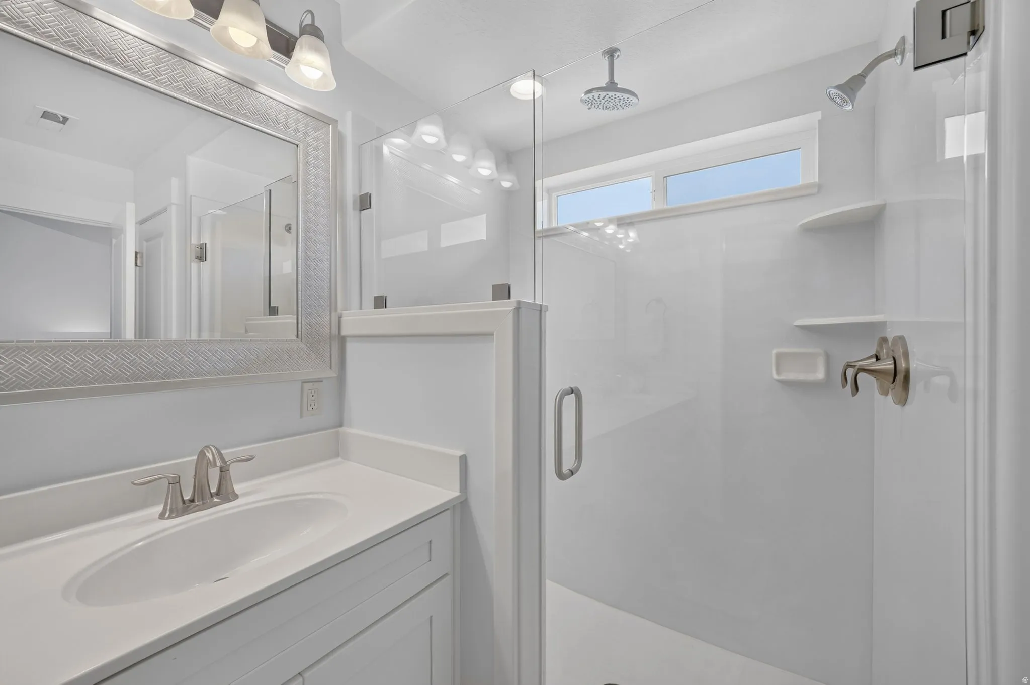 Vanity with a single basin sink, brushed nickel faucet, and integrated countertop