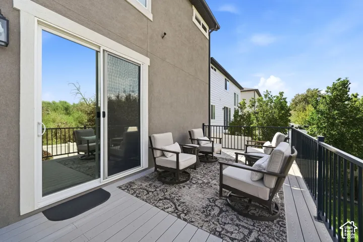 Spacious outdoor deck featuring composite decking and a black metal railing