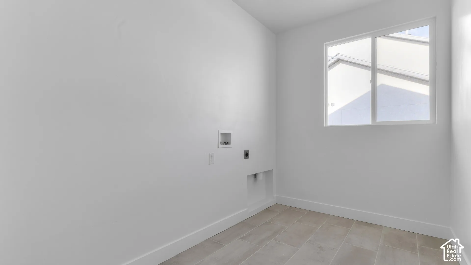 Tile flooring, white walls, and a window providing natural light