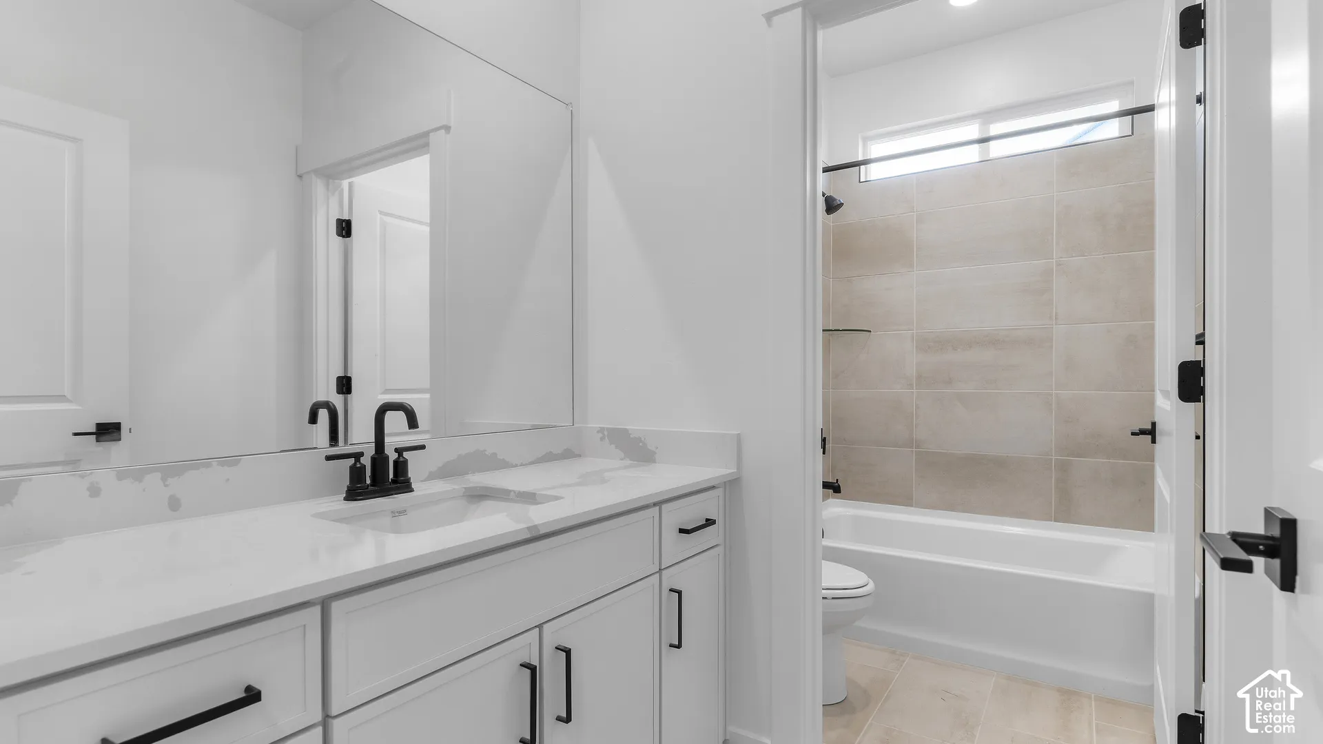 Dual basin vanity with white cabinetry and stone-finish countertop