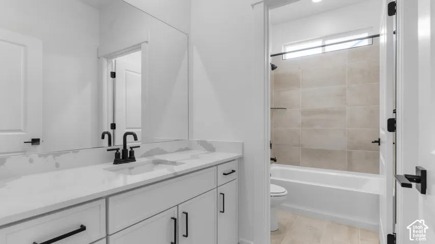 Dual basin vanity with white cabinetry and stone-finish countertop