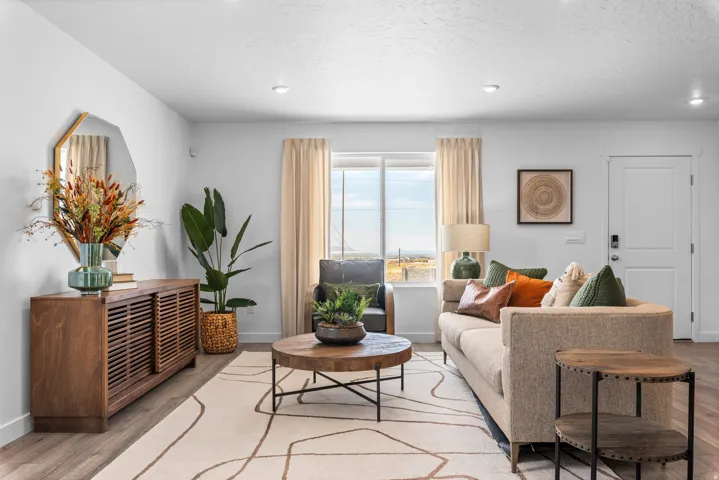 Recessed lighting, wood-finish flooring, and white walls