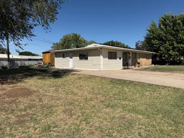 Single-story residence featuring a brick and siding exterior, an attached carport, and a concrete driveway