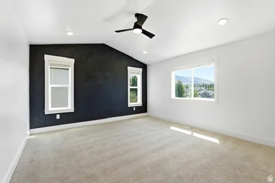 Vaulted ceilings, recessed lighting, and a contemporary ceiling fan