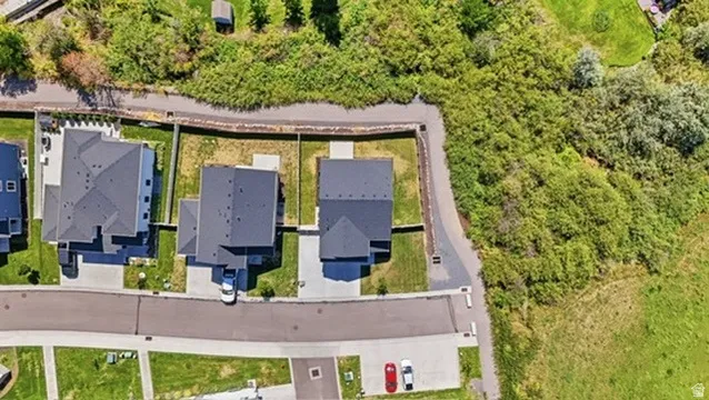 Aerial overview of residential properties featuring dark-toned roofing and paved driveways