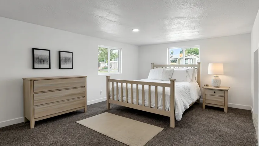 Recessed lighting, light-toned walls, and dark-toned carpeting