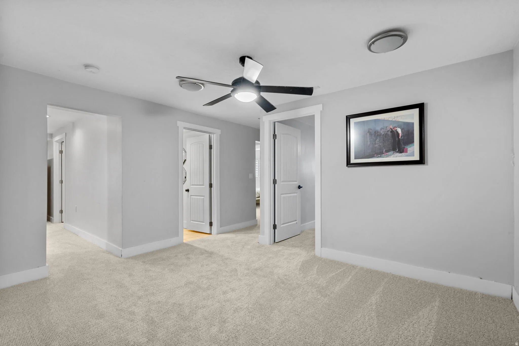 Plush carpeting, recessed lighting, and a ceiling fan with light fixture