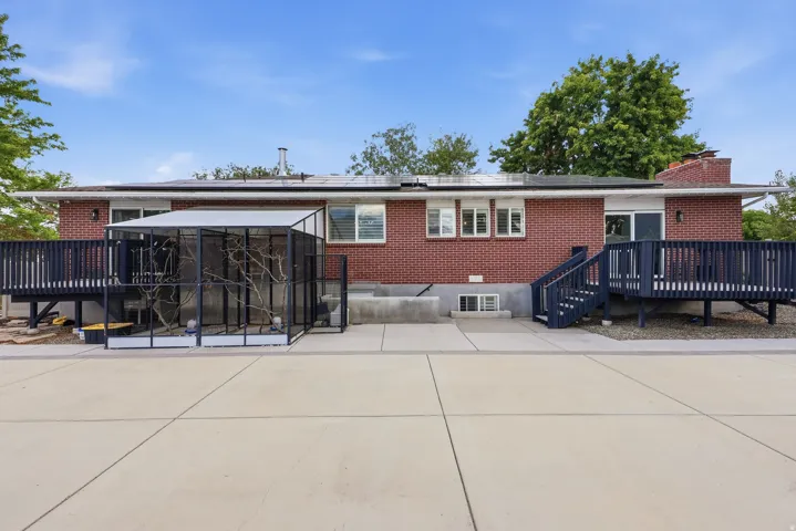 Red brick exterior with white trim windows and a full light sliding door