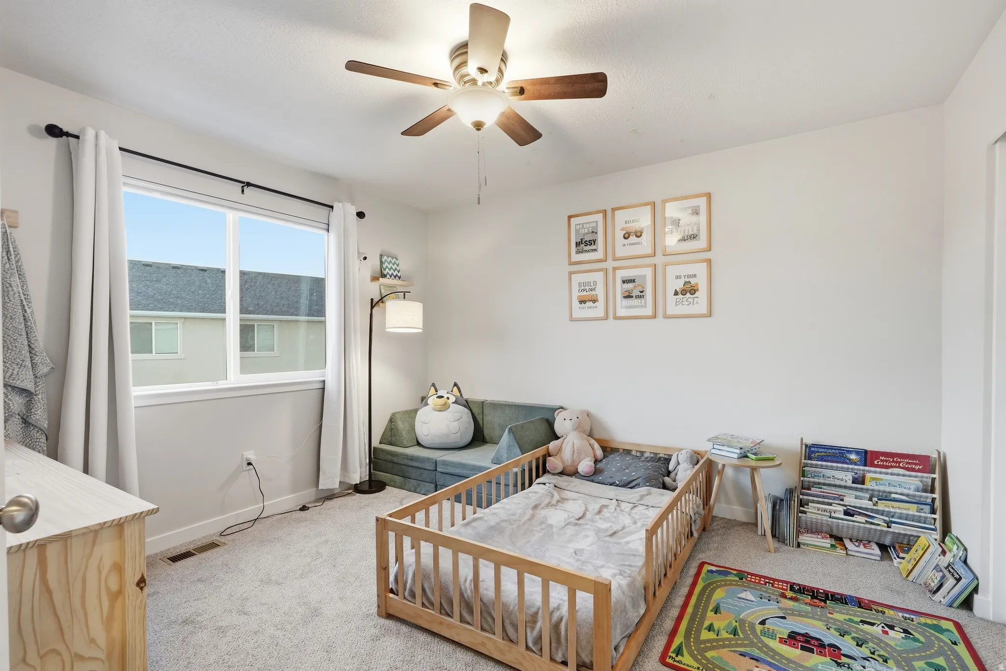 Light-colored wall-to-wall carpeting, white walls, and a window with white trim
