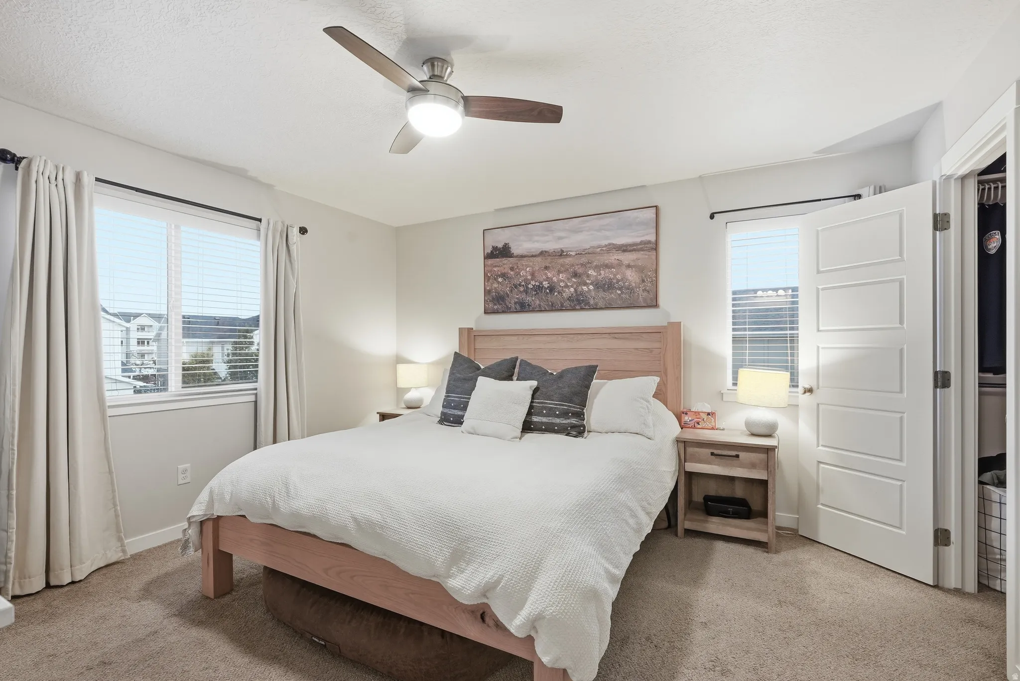 Recessed lighting, ceiling fan with light fixture, double pane windows, paneled interior door, and carpet flooring