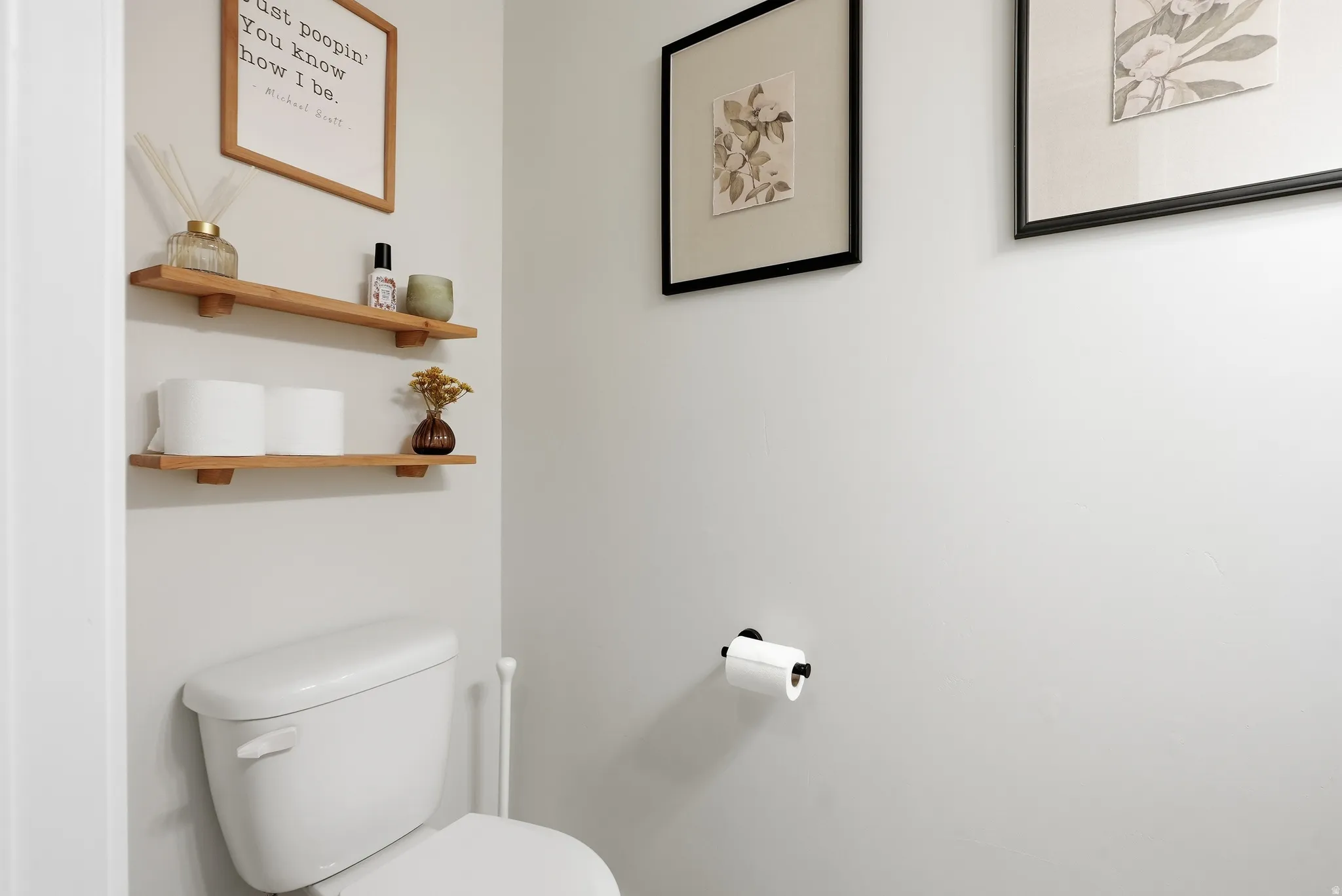 White commode with two wood-finish wall shelves