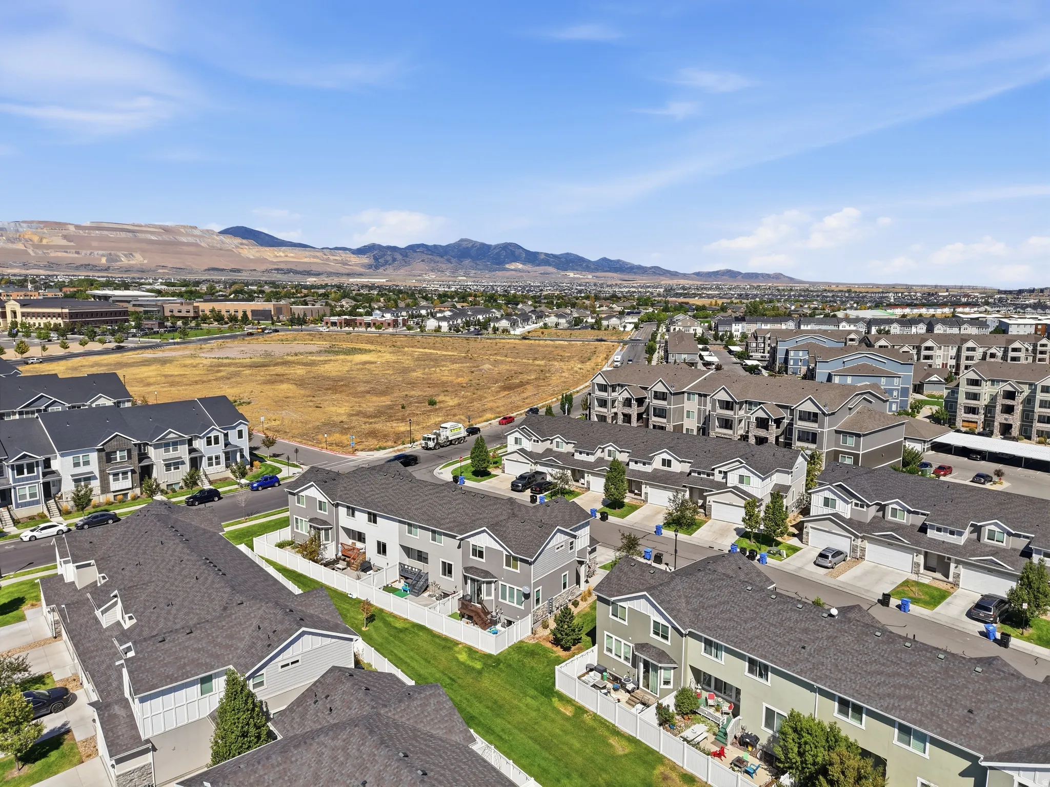 Aerial perspective showcasing a residential community with varied architectural styles, including townhomes and apartment buildings