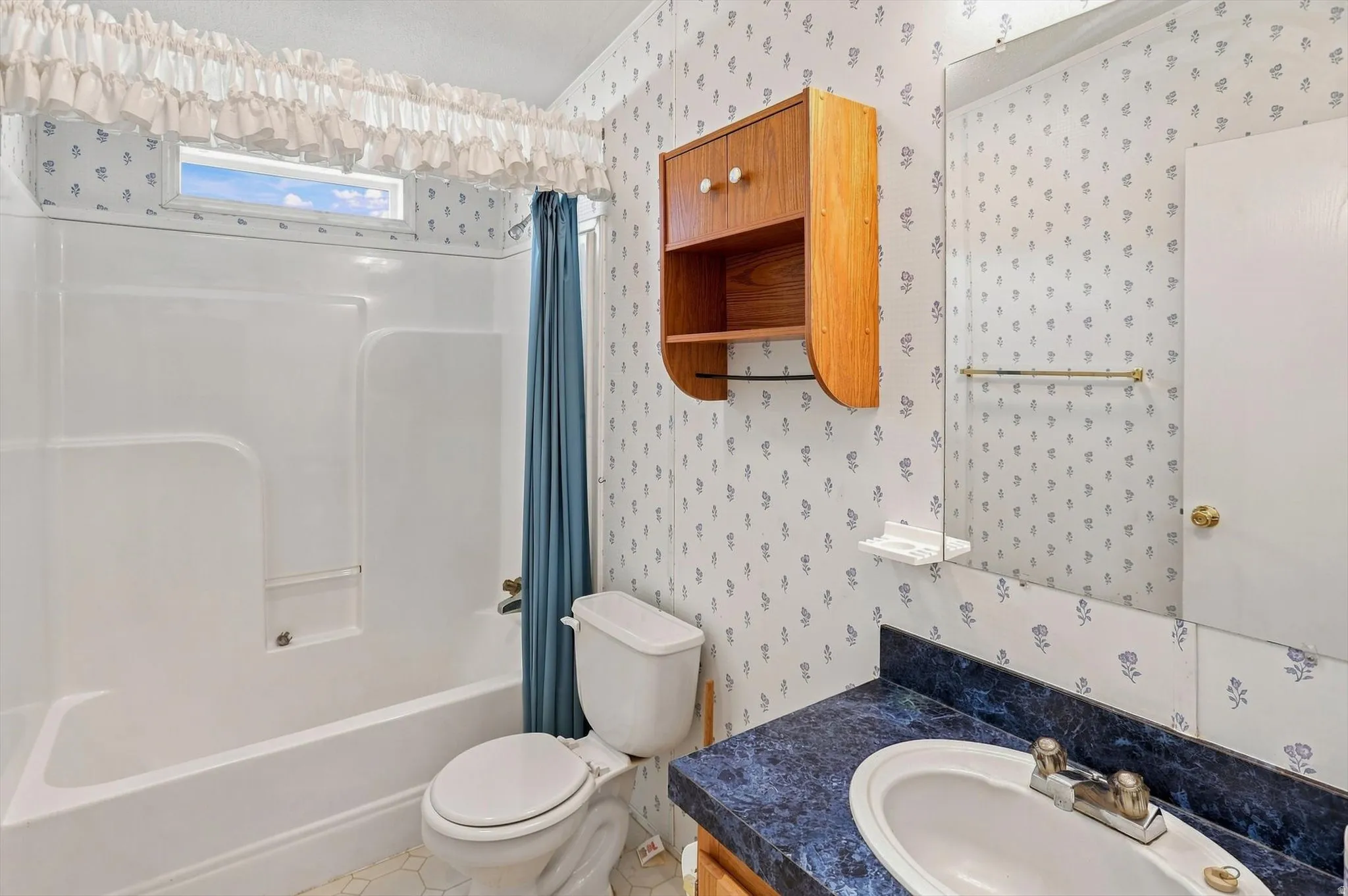 White tub-shower combination with a transom window