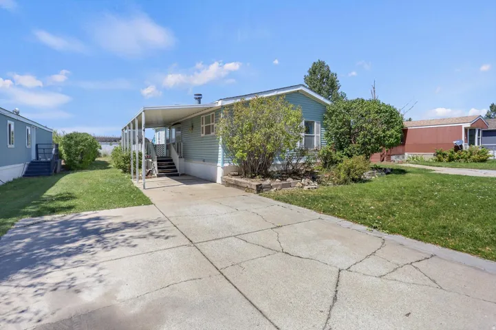 Welcoming front approach featuring a concrete driveway and walkway leading to the entry
