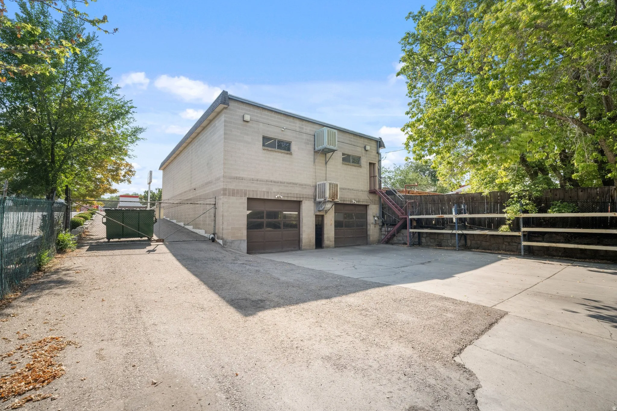 Concrete block exterior with two garage doors basement level