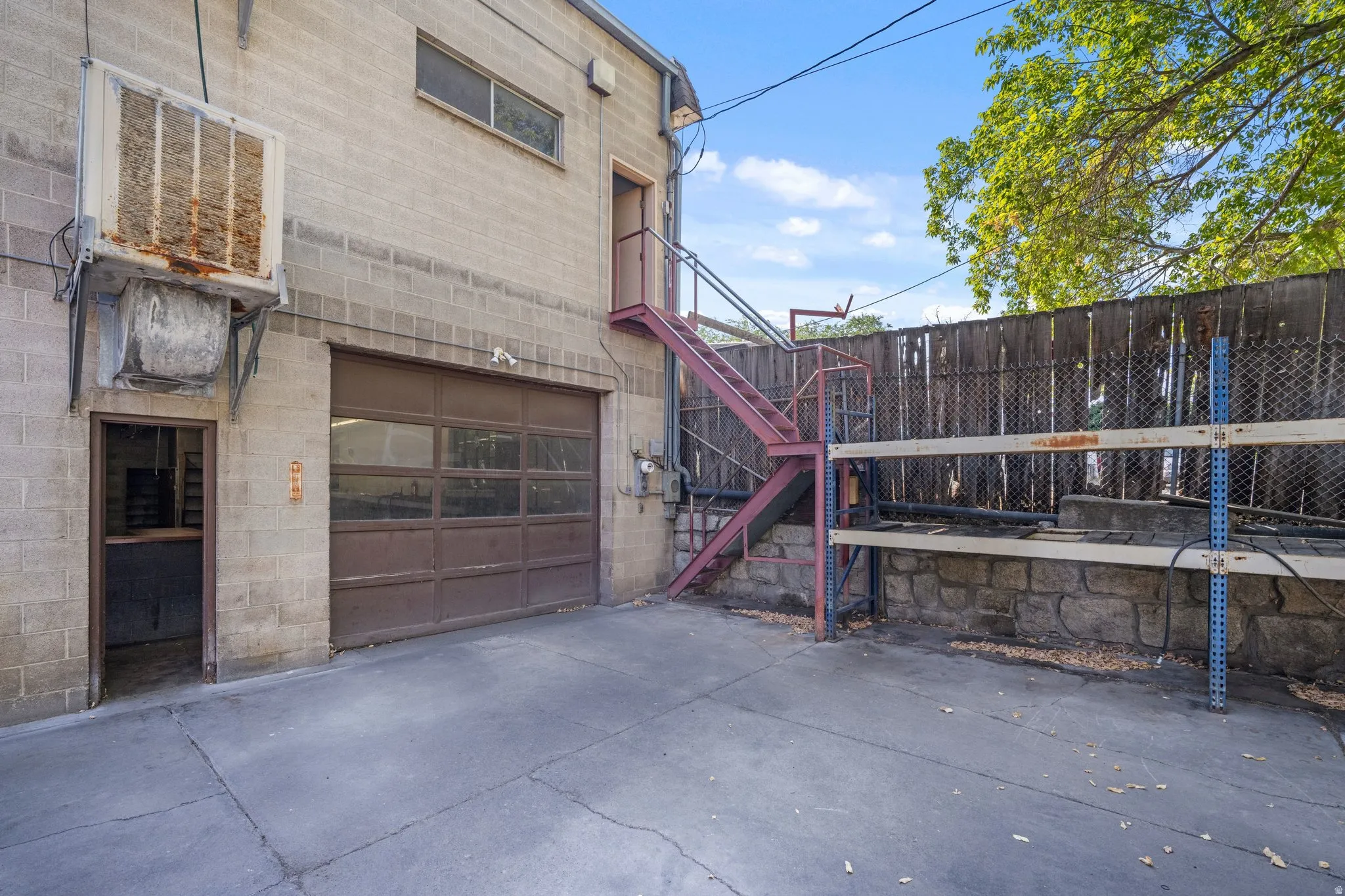 Concrete paving leading to a garage door with clear panels